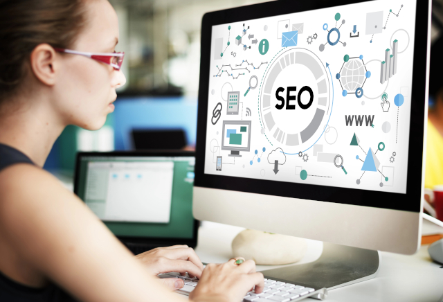 Woman working on SEO and Marketing at computer